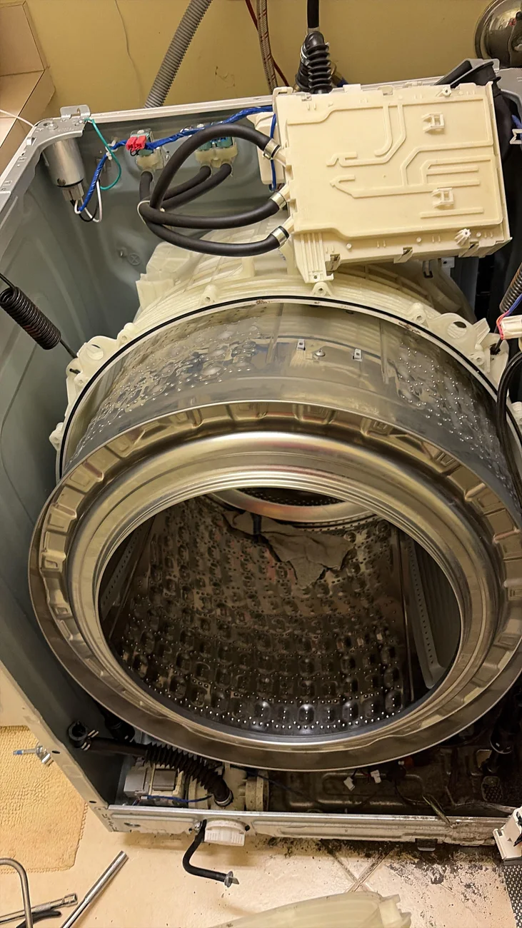 A washing machine opened for service.
